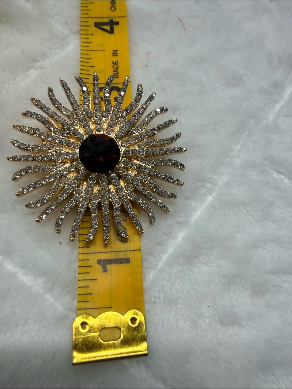 Radiant Gold-Tone Sunburst Brooch with Deep Red Center